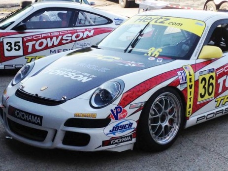 Two parked Porsche 997 GT3 cup cars with TPC Racing race livery