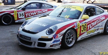 two parked Porsche 997 GT3 cup cars with TPC Racing race livery