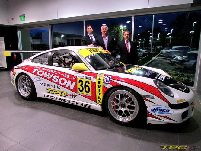 Mike Levitas of TPC Racing posing with his GT3 Cup Car at Porsche of Towson